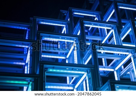 Abstract conceptual background with neon blue cubes in the dark, modern cover design. Background and texture of cube geometric shapes Royalty-Free Stock Photo #2047862045