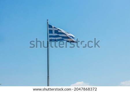 Close up view of Greece flag on blue sky background. Greece.