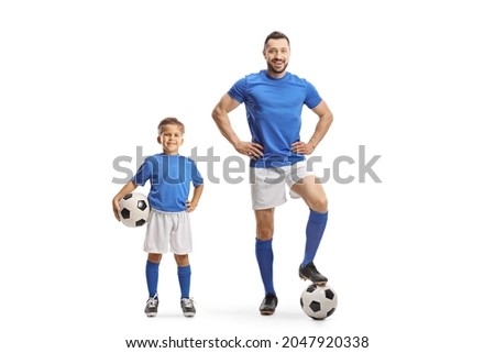 Man and boy with soccer balls wearing same color jersey isolated on white background
