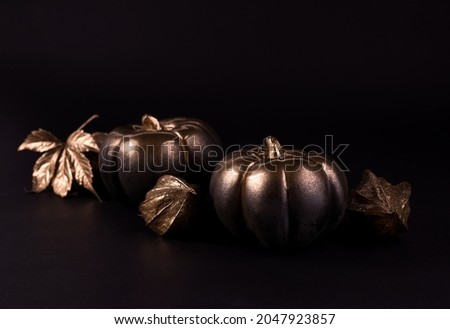 Gold and black luxury pumpkin with gold autumn leaves. Minimalist banner good for thanksgiving and Halloween.