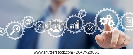 Operations management involving business process and workflow, problem solving, high performance, monitoring and evaluation, quality control. Concept with manager touching gears and icons. Royalty-Free Stock Photo #2047928051