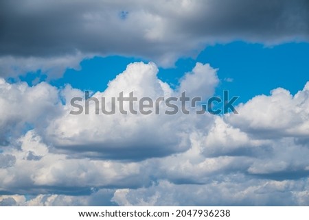 Blue sky background with white clouds. Beautiful clouds at sunset. Peace and idyll in heaven.