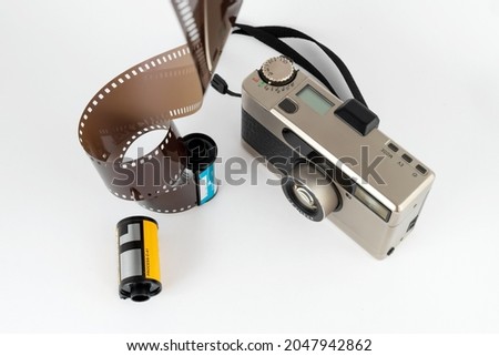 film camera with a film and a reel on a white background
