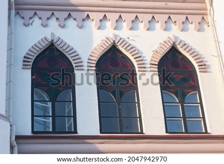 Stained glass arched windows in the Gothic style. Architectural elements. Horizontal photo.