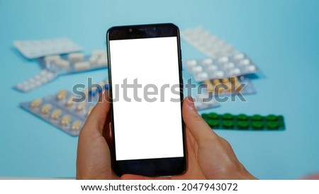 Patient hand using smartphone with Chroma Key Display. Phramaceutical use. Drugs. Pills. Prospectus. Using Smarthphone with Mockup, Green Screen Medical.