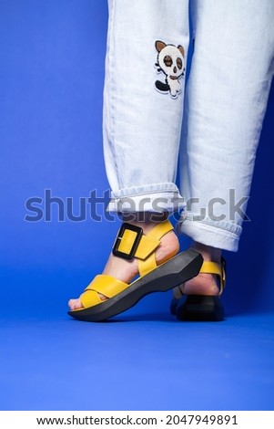 Yellow women's summer shoes on the foot for every day.