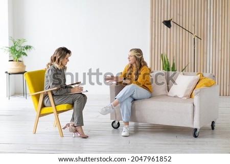 Woman psychologist works with teenage girl in her office. Psychological health. Royalty-Free Stock Photo #2047961852