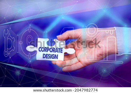 Hand writing sign Corporate Design. Conceptual photo official graphical design of the logo and name of a company Hand Holding Jigsaw Puzzle Piece Unlocking New Futuristic Technologies.