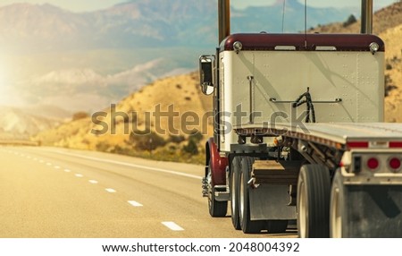 Heavy Duty Freight Theme. Semi Truck with Flatbed Trailer on a Scenic Utah Interstate 70 Highway. American Transportation Industry. Royalty-Free Stock Photo #2048004392