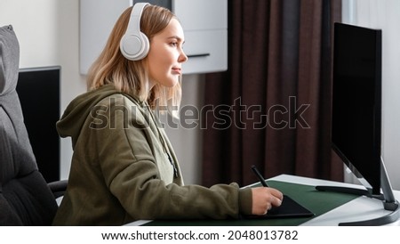 Young woman graphic designer freelancer busy working remote from home using pc computer and graphics tablet in living room interior. Casual teenager girl in studying visual arts. Long web banner