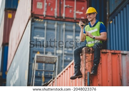 foreman or engineer are work in container shipping industry warehouse, logistic transport to import and export cargo at delivery storage port terminal, man are work to control a business box