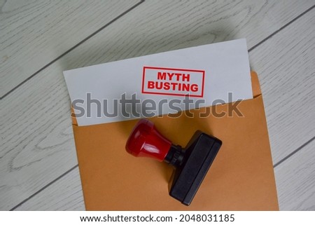 Myth Busting text on document above brown envelope. Royalty-Free Stock Photo #2048031185