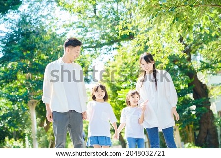 4 family members taking a walk         Royalty-Free Stock Photo #2048032721