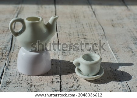 Toy tea party. Little toy dishes. Toy kettle and cup.