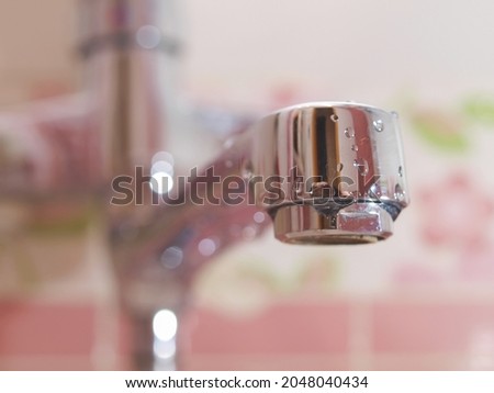 Water tap in the bathroom. Close-up shooting. Focus on the leading edge of the tap. Royalty-Free Stock Photo #2048040434