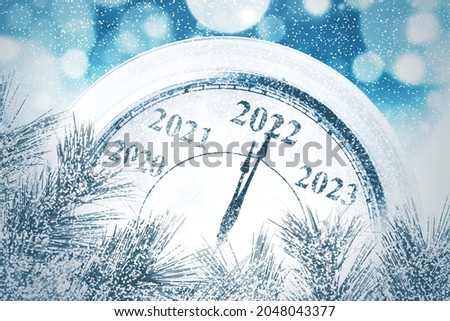 Close up of classic clock counting last moments before Christmas and New Year 2022 event with blurred sparkling lights background