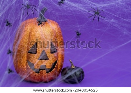 Modern postcard for a Halloween party. Pumpkin Jack, black pumpkins, cobwebs, spiders on a trendy purple background. Banner with copy space for text. 