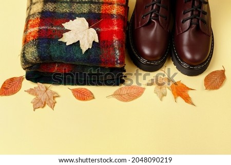 autumn background with scarf and boots with fichtiy. free space for text