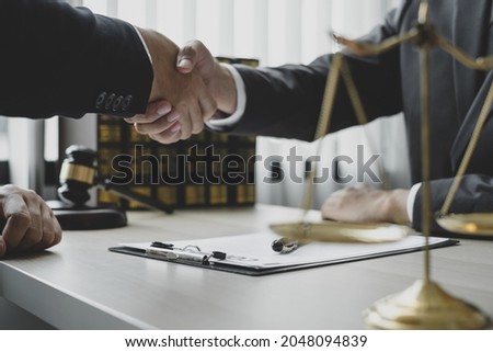 shake hand Professional man lawyers work at a law office There are scales, Scales of justice, judges gavel, and litigation documents. Concepts of law and justice.