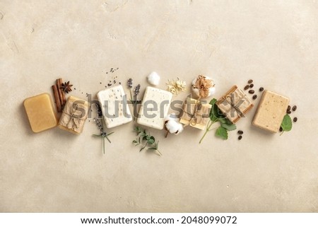 Handmade soap bars and ingredients on natural stone background, top view. Handmade organic soap concept Royalty-Free Stock Photo #2048099072