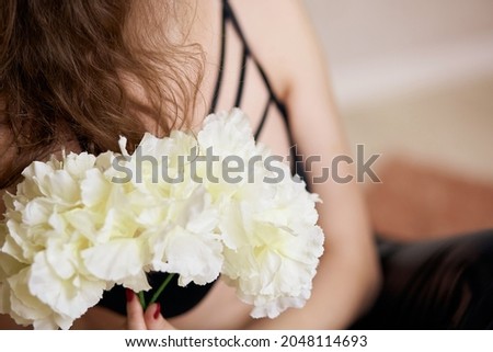 Female bust close up and white flowers. High quality photo