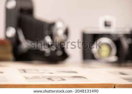 VINTAGE PHOTO CAMERAS ON THE WOODEN TABLE, RETRO BACKDROP BACKGROUND