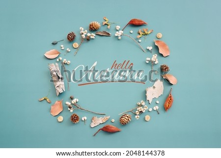 Top view image of autumn forest natural composition over blue background .Flat lay