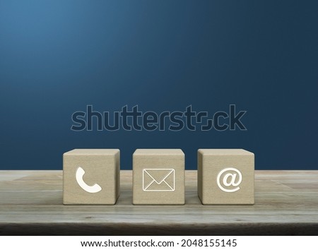 Telephone, mail, email address icon on wood block cubes on wooden table over light blue gradient background, Business customer service and support online concept