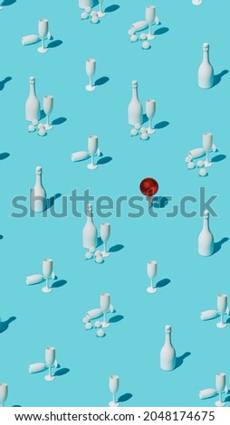 Christmas pattern with champagne bottles, glasses and red ball ornament with doll legs on pastel blue background. Creative Xmas eve celebration or New Year party concept. Fashion minimal art.