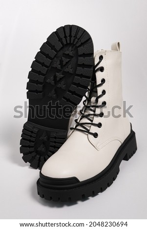 White womens autumn rough army boots on a tractor sole with laces, on a white background