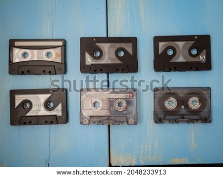 Group of Retro Audio Tape Cassettes on a Blue Wooden Background
