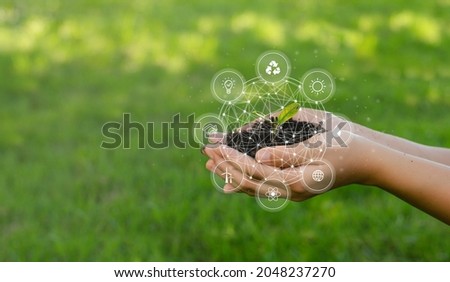 ESG icon concept circulating in hands for environment, society and governance. Esg. in sustainable business on networked connections on green background. Royalty-Free Stock Photo #2048237270