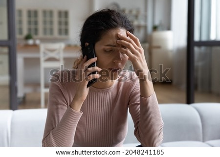 Upset young Caucasian woman have cellphone call hear bad unpleasant news on gadget. Unhappy millennial female talk speak on smartphone distressed frustrated with negative message. Failure concept. Royalty-Free Stock Photo #2048241185