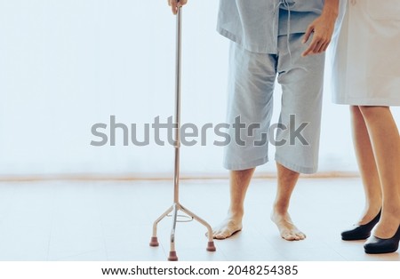 Young patient man uses walking stick due to muscle severe weakness, numbness and tingling at his toes after getting vaccination. Woman doctor diagnose vaccinated side effects Guillain Barre syndrome.