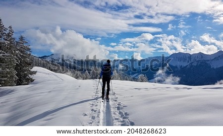 Ski touring in a peaceful winter landscape covered with deep snow. Laterns, Vorarlberg, Austria. Royalty-Free Stock Photo #2048268623