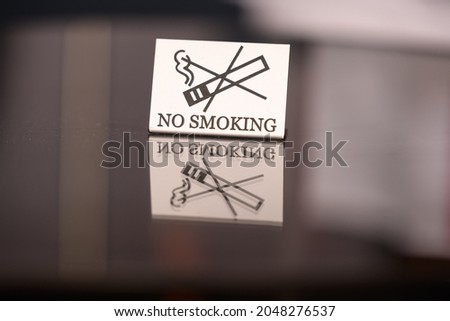 Warning sign. no smoking on the table in the room. Iron plate on the table does not smoke close-up. horizontal view. copy space