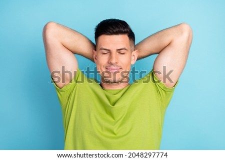 Photo portrait man in green t-shirt calm relaxing after work day isolated pastel blue color background