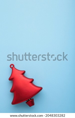 Christmas toy pine tree on blue background. Vertical photo. Top view