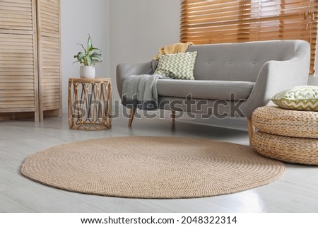 Stylish rug on floor in living room Royalty-Free Stock Photo #2048322314
