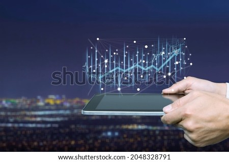 Businessman forex trader using tablet technology indicating trend growth in the market