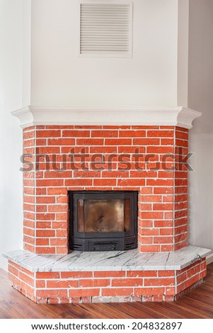 Modern fireplace on a brick wall