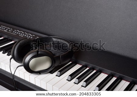 Close-up headphones on piano keyboard