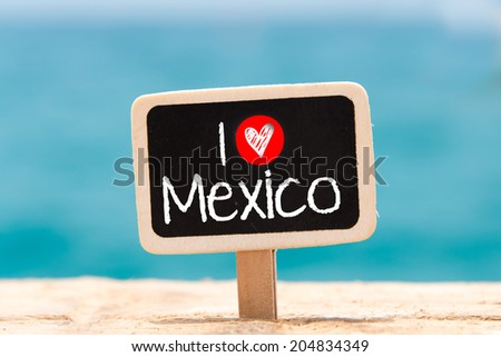I love Mexico by hand on a blackboard on the background of the sea