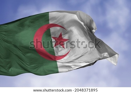 Algeria flag isolated on the blue sky with clipping path. close up waving flag of Algeria. flag symbols of Algerian.