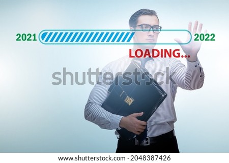 Businessman pressing virtual button with year 2022