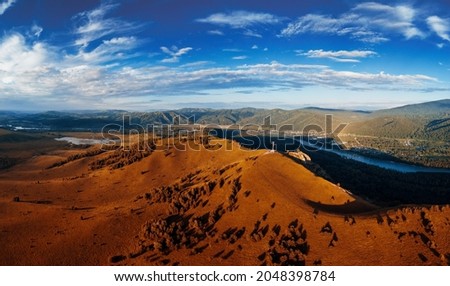 Aerial autumn panorama drone shot of beauty dawn on the peak, in the mountains in Altay, summertime