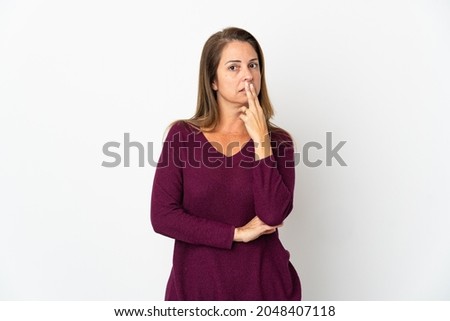Middle age Brazilian woman isolated on white background surprised and shocked while looking right