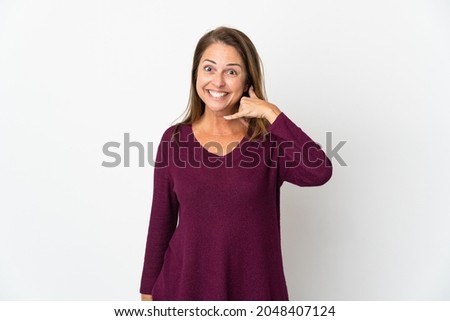 Middle age Brazilian woman isolated on white background making phone gesture. Call me back sign
