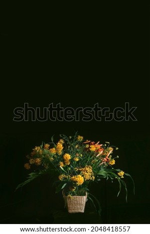 a stylish bouquet of yellow flowers with lilies on a dark background. Still life in the style of old Dutch masters of painting. Large format for printing paintings in the interior. space for copying.