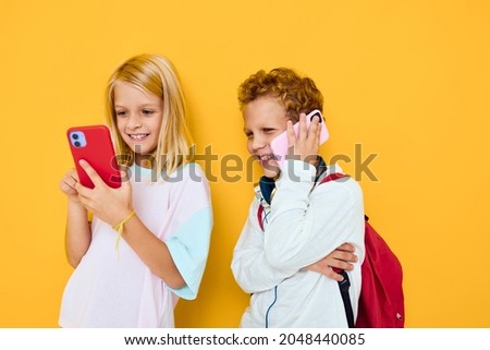 Two kids boy and girl talking and smiling emotions joy concert of addiction of children and gadgets